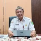 Kepala Dinas Sosial Kabupaten Sumenep, R. Abd. Rahman Riadi, saat diwawancarai ruangannya (Istimewa - garudajatim.com)